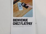 someone is holding a cell phone in their hand on a table