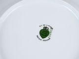 a white plate with a green heart and a crown on it