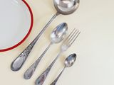 a plate, spoons, and a bowl on the table