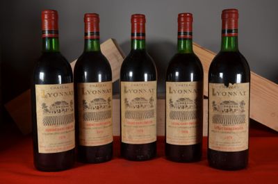 four bottles of wine are lined up on a table