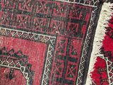 an image of a close up of a red rug with a black border