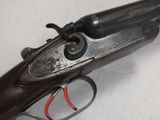 an old gun that is on display on a white surface