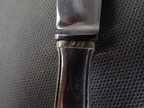 a knife that is sitting on top of a piece of metal