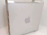 an apple computer sitting on top of a white table next to a white wall