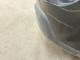 a close up of the front of a car with a dent in it