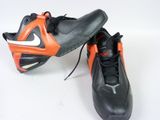 pair of black and orange shoes on a white surface
