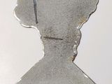 a metal sculpture of a man with a hat on it ' s head