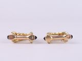 a pair of gold and black enamel cufflinks