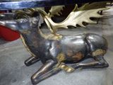 une statue de cerf assise sur le sol
