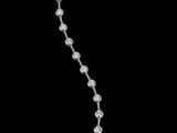 a black and white photo of a string of beads