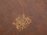 a brown leather book with a gold design on it
