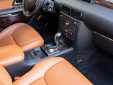 dashboard of a car with tan leather seats and a center console