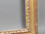 an old picture frame with a gold leaf pattern on the edge