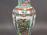 a vase that has a bird and flowers on it