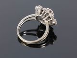 a close up of a diamond ring on a black surface