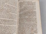 an open book on a table with a white background