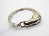 a close up of a silver ring on a white surface