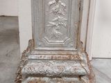 an antique cast iron pedestal with a decorative design on the top