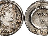 a silver coin with an image of a woman on it