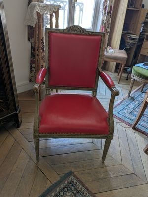 a red chair that is sitting in a living room