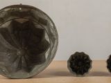 a picture of a glass vase and two small pieces of glass