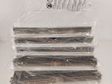 four pieces of wood are wrapped in plastic on a white surface
