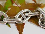 a close up of a chain with a heart on it