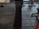 an image of a gym room with a bench and exercise equipment