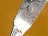 a close up of a fork with a piece of food on it
