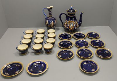 a lot of blue and white plates and a blue and gold teapot