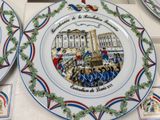 many plates that have different designs on them on the table