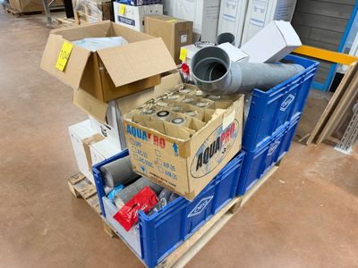 a pile of boxes and a blower on a pallet