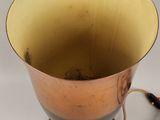a gold vase with a cord attached to it