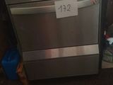 a dishwasher in the kitchen with a price tag on it