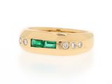 a close up of a gold ring with emerald and diamonds
