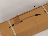 a cardboard box with a knife on it sitting on the floor