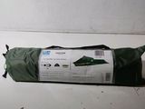 a roll of fabric on the floor next to a bag