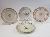 trois assiettes à motifs floraux posées sur une surface blanche
