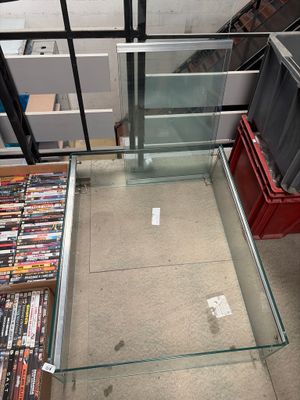 a glass table with a lot of dvd ' s on it