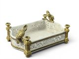 a white and gold tray with two birds on it