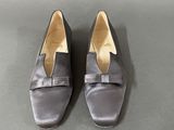 grey satin slippers with a bow on the toe