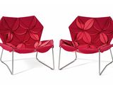 pair of red modern lounge chairs on chrome steel legs