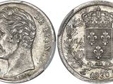 a silver coin with a crown on top of it