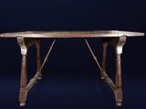 an old wooden table with a marble top on a dark blue background