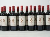 six bottles of red wine are lined up in a row