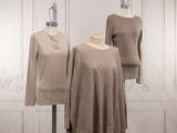 three mannequins of different sizes and colors are on display in a room