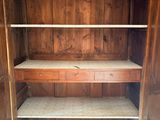 a wooden cabinet that has a shelf in the middle of it