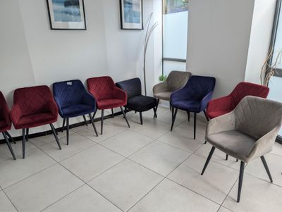 several chairs are lined up in a row in a waiting room