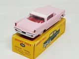 a pink toy car sitting on top of a yellow box