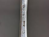 a close up of a spoon on a table with a black background